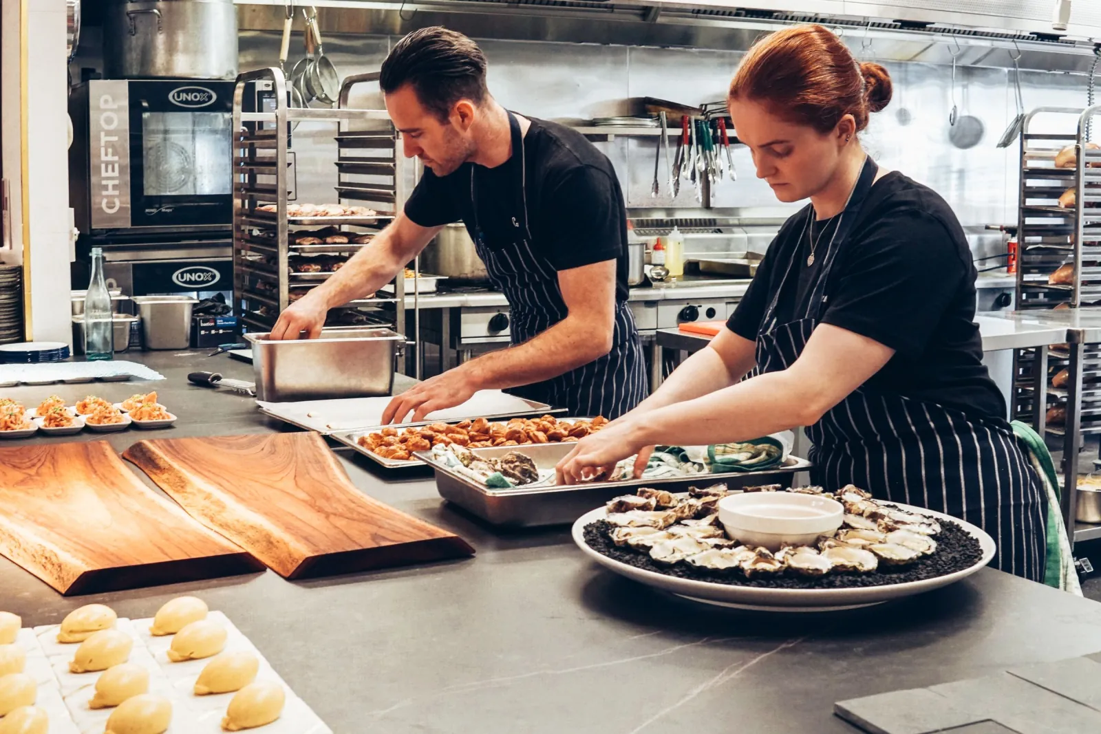 Hospitality colleagues preparing food in a kitchen